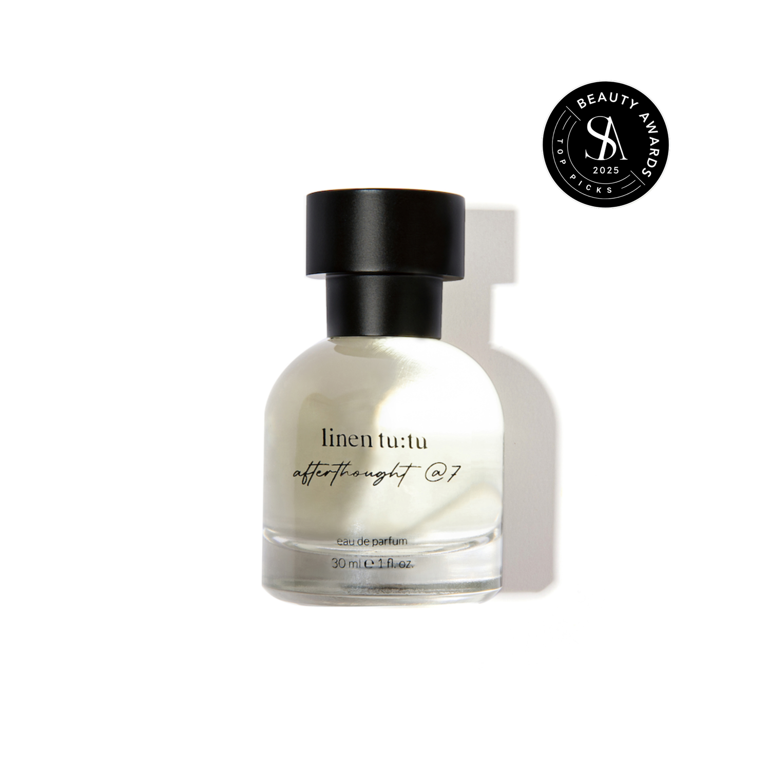 Perfume bottle labeled &quot;linen tutu afterthought @7&quot; with a black cap on a white background, featuring a Skin Anarchy Top Picks 2025 award badge.
